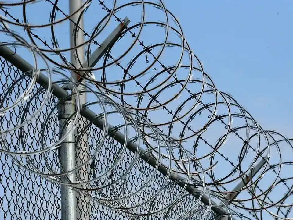 Commercial chain-link fence topped with barbed wire